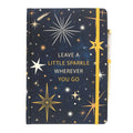 Notebook with starry design and motivational quote on a white background